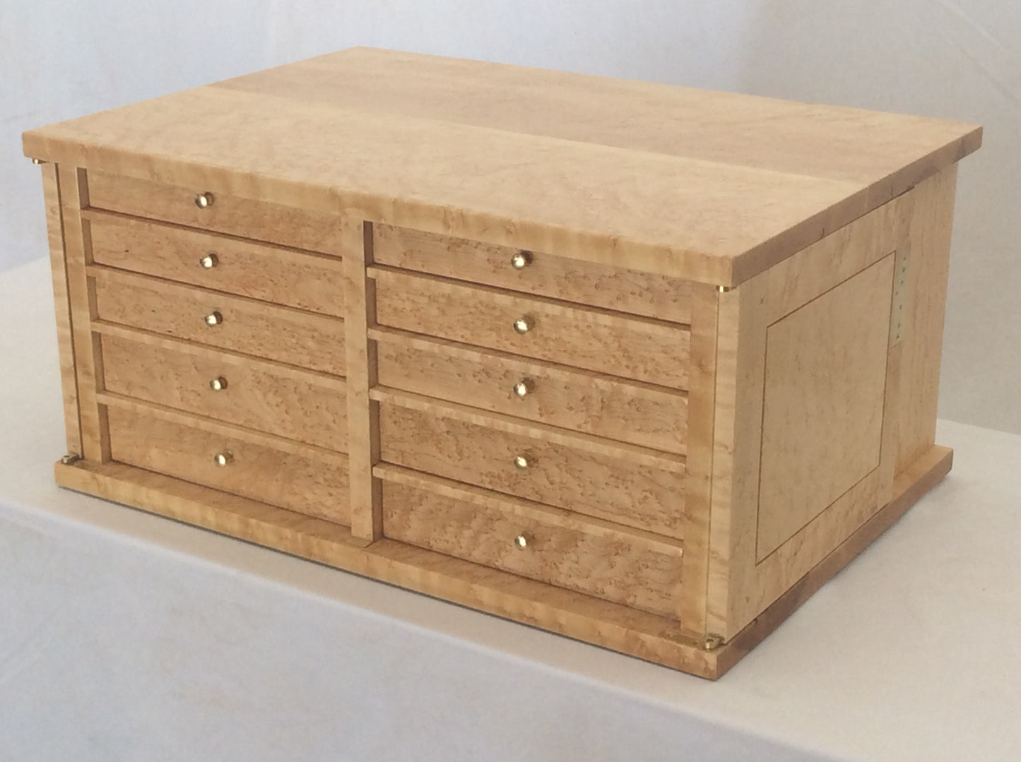 Photo showing the cabinet with both doors open and flat against the sides of the cabinet. It has a simple and elegant look and function that requires hours of precision fitting.