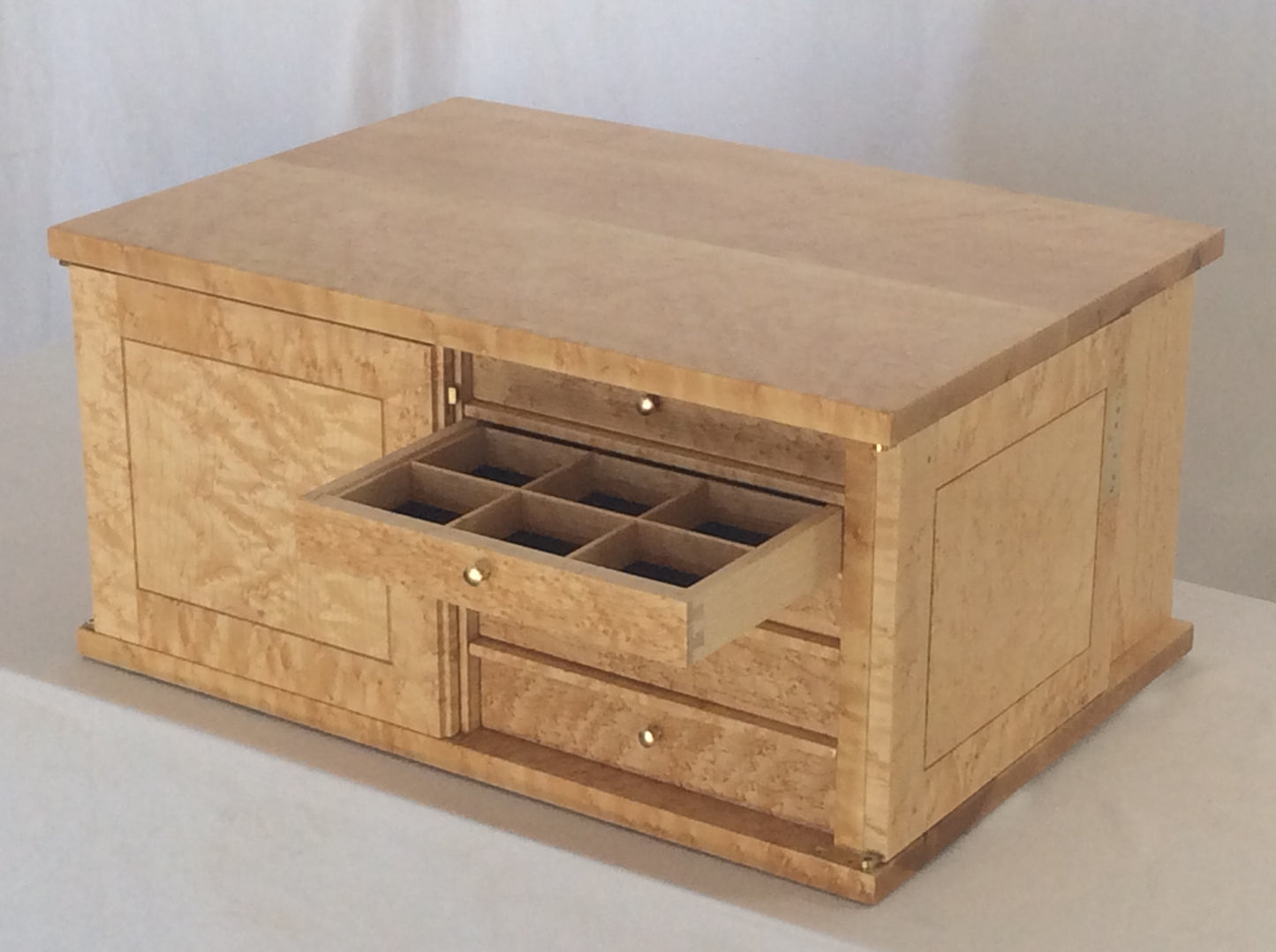 Photo showing the machine cut dovetails on the side of the drawer front and drawer side. It also shows how the drawer can be organized with dividers. The drawer has a black velvet liner.