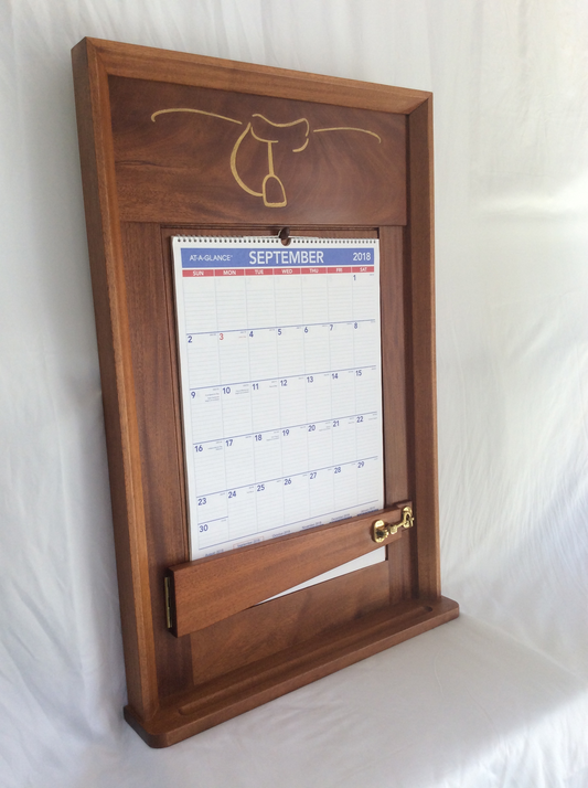 This calendar wall frame photo shows the completed frame with the gold paint and laser engraved logo on the top rail. 