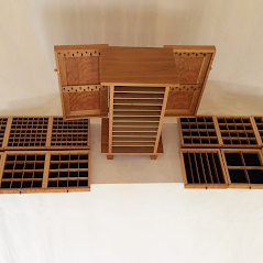 This image shows the way the drawer dividers can be configured to hold a collection. The open doors show two ledger strips with each strip having eleven necklace holders.